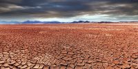 Solo seco e rachado sob céu ameaçador revela os efeitos extremos das mudanças climáticas — um alerta visual para o futuro que já chegou.