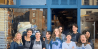 Na fachada azul icônica da Bread by Bike, a dedicada equipe exibe com orgulho o local que virou referência em fermentação natural e comunidade em Kentish Town.